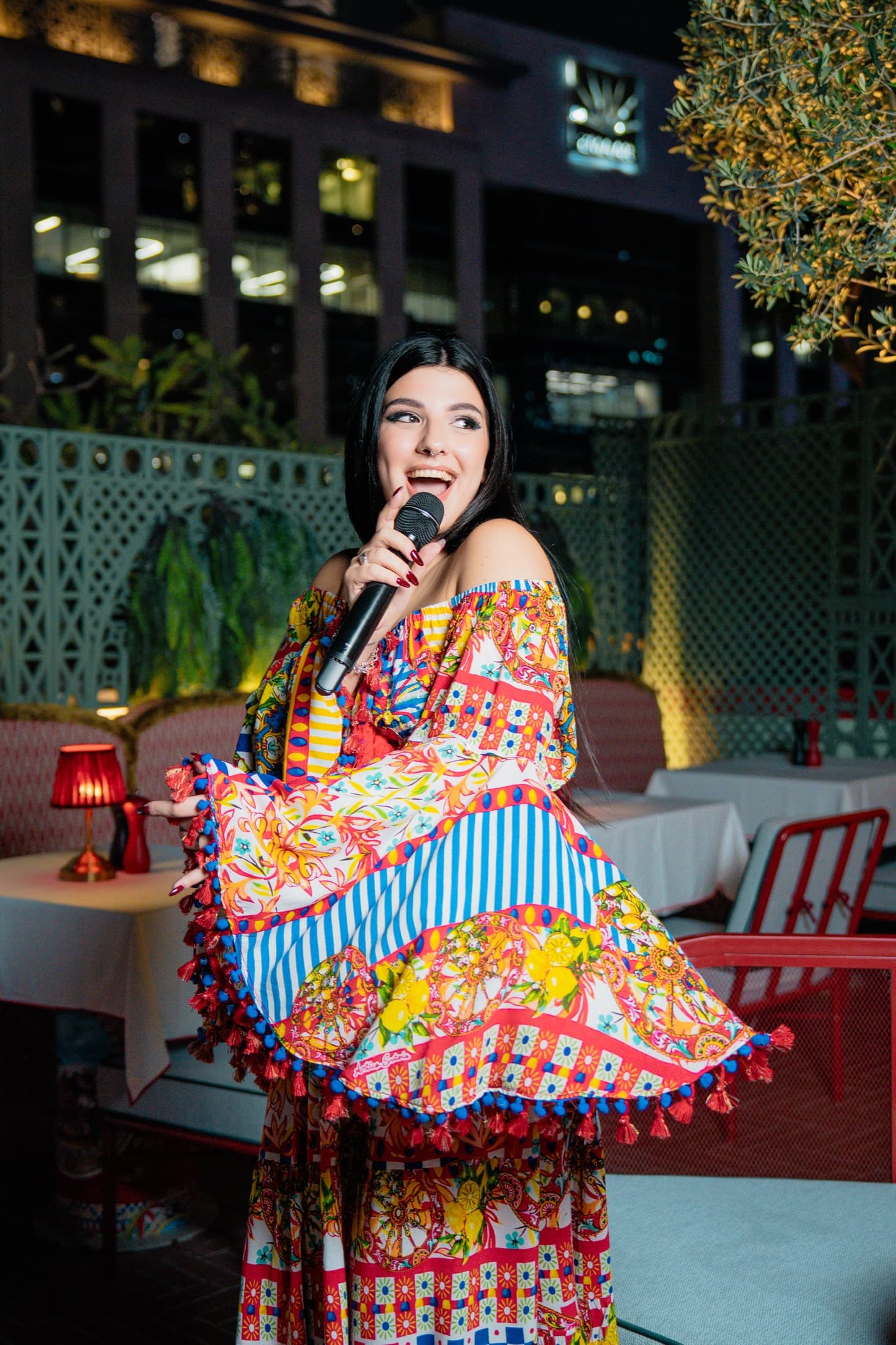 Carol Magagna smiling during a rooftop performance in Dubai